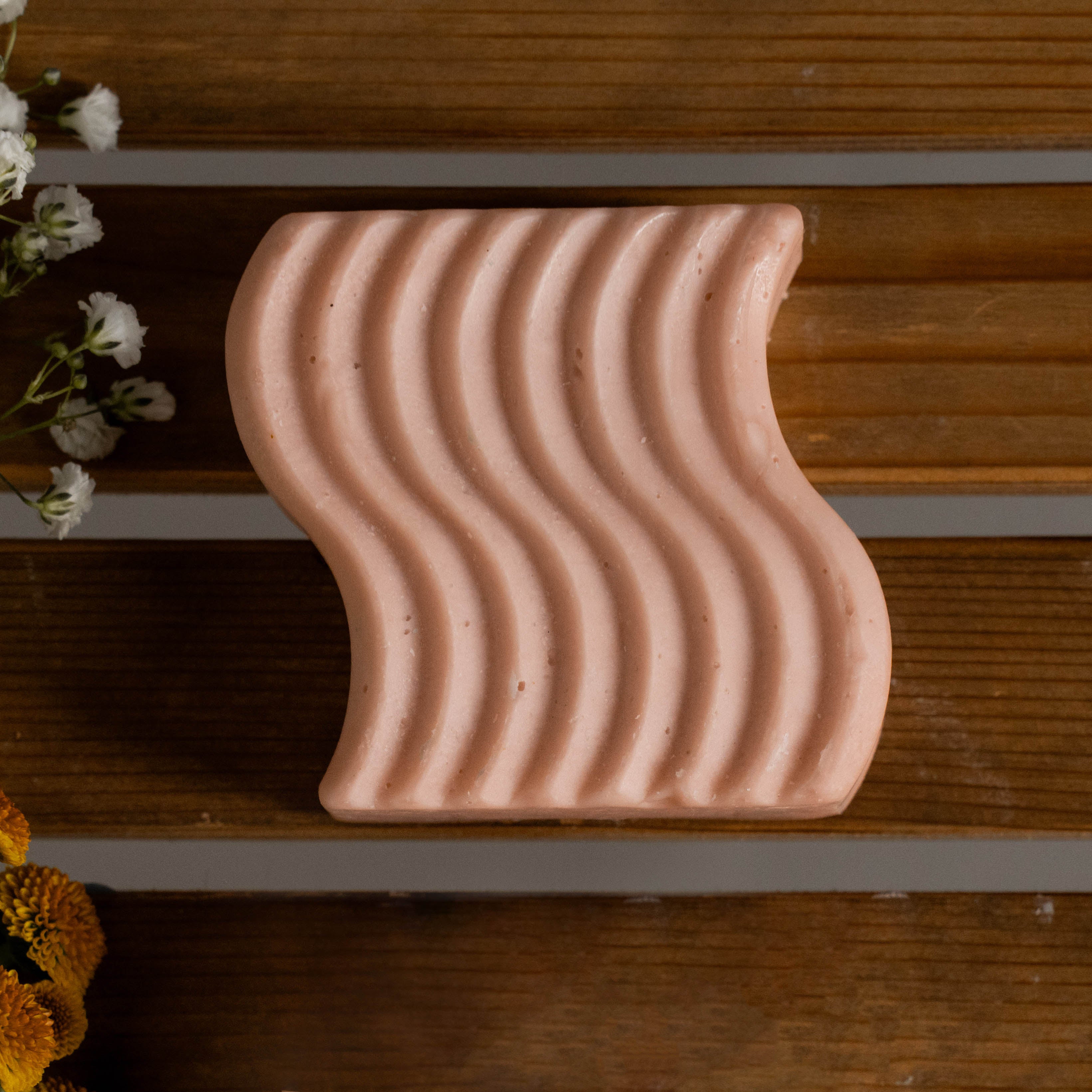Top down flat lay of Thick + Voluminous Shampoo Bar with natural elements – eco aesthetic